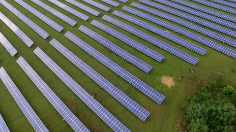 Aerial view  flight over solar panels modules on green meadow Stock Footage 63526817