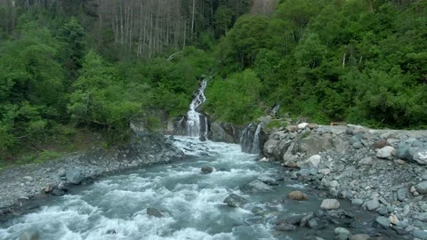 Aerial view flight over a swift mountain river with a stormy waterfall. Stock Footage 156346792