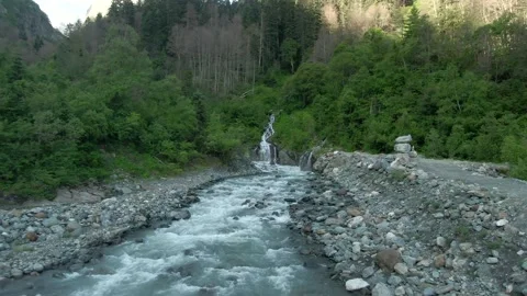 Aerial view flight over a swift mountain river with a stormy waterfall. Stock Footage 156346807