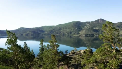 Aerial view. Flight over tree tops in the mountain forest Mountain lake panorama Stock Footage 142197416