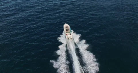Aerial view of floating boat on blue sea at sunny day. Fast boat on the sea Stock Footage 252818650