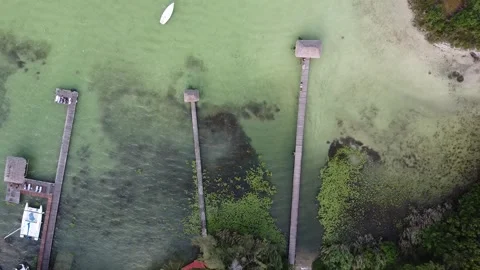 Aerial view of floating house over beautiful laguna Stock Footage 344680667