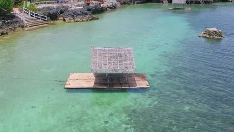 Aerial view of floating hut on clear tropical sea, Philippines Stock Footage 325218003