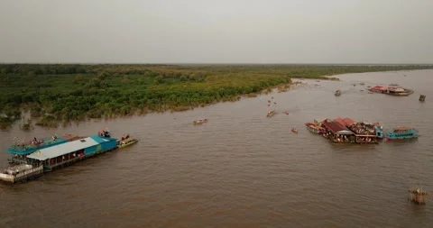 Aerial view of floating platforms and boats near the mangrove edge of Tonle Sap Stock Footage 323157972