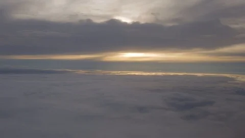 Aerial view floating towards the sun setting between the clouds high in the sky 스톡 동영상 101302634