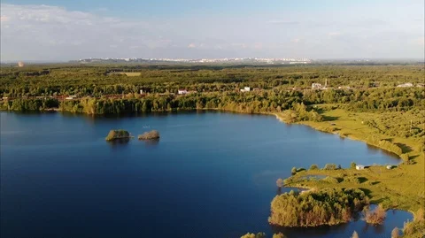 Aerial view of the flooded quarry, with blue water and winding shore Stock Footage 106926458