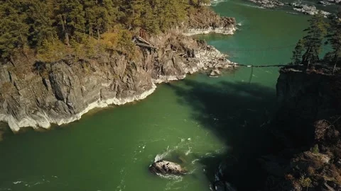 Aerial view flow of the mountain green river Katun. The bridge between two Stock Footage 149477013
