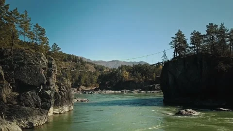 Aerial view flow of the mountain green river Katun. The camera flies under a Stock Footage 149477190