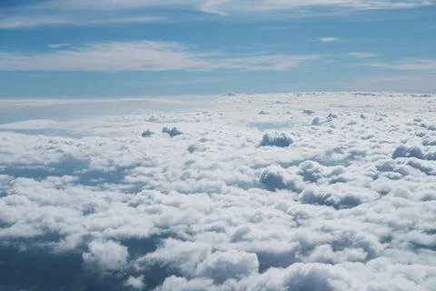 Aerial view fluffy cloud and sky from window of airplane Stock Photos
