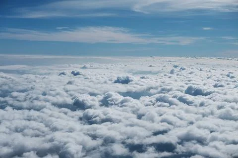 Aerial view fluffy cloud and sky from window of airplane Stock Photos