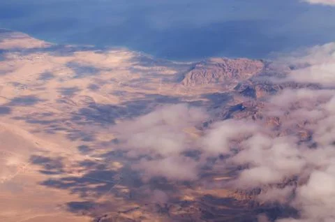 Aerial view fluffy clouds above desert landscape and Suez Gulf in Egypt Stock Photos