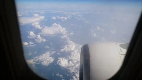 Aerial View Fluffy Clouds and Airplane Engine During Flight Above Landscape on Stock Footage 312039029