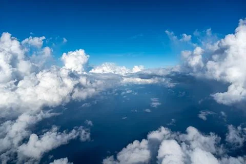 Aerial view of fluffy clouds over the Pacific Ocean in Polynesia Stock Photos