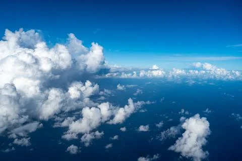 Aerial view of fluffy clouds over the Pacific Ocean in Polynesia Stock Photos