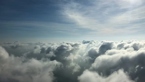 Aerial view of fluffy cloudy sky with an ocean below, serene sunrise Stock Footage 121945806