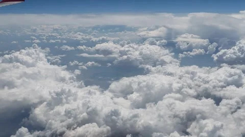 Aerial view of fluffy cumulus clouds from an airplane window. 스톡 동영상 336931078