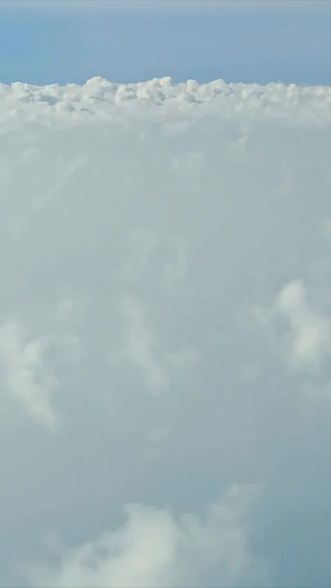 Aerial view of fluffy white clouds, A serene aerial view of a vast expanse of Stock Footage 310310669