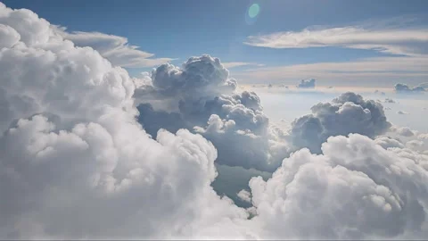 Aerial view of fluffy white clouds in blue sky with sunlight Stock Footage 330665294