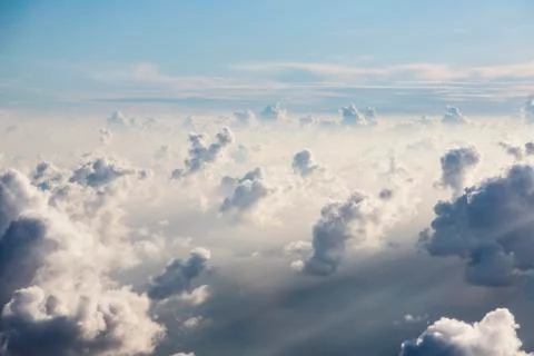 Aerial view fluffy white clouds in sunny, ethereal sky Stock Photos