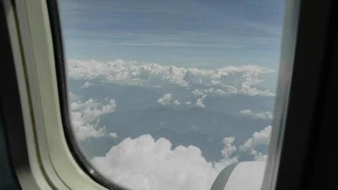 Aerial View of Fluffy White Clouds Through Airplane Window Stock-Fotos