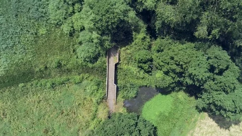 Aerial view, fly down move. Drone over old small sandstone roman bridge Stock Footage 93488045