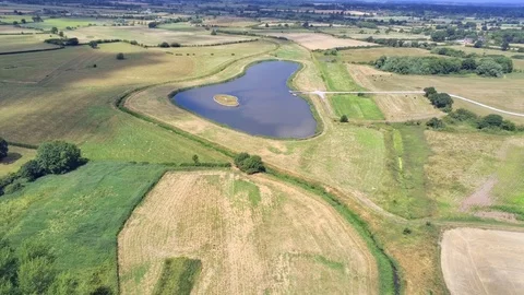 Aerial view, fly forward move. Drone panorama of plains and small pond 動画素材 93899947