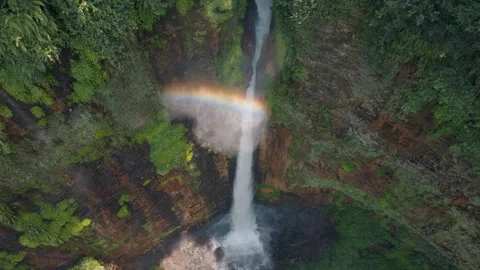 Aerial view fly orbiting over Kapas Biru Waterfall with rainbow, Java, Indonesia 스톡 동영상 272980882