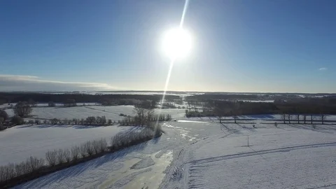 Aerial view  fly over beautiful snowy landscape with sun and blue sky in germany Stock Footage 71484289