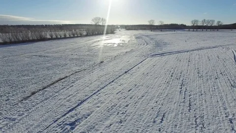 Aerial view fly over beautiful snowy landscape with sun and blue sky in germany Stock Footage