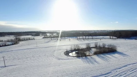 Aerial view  fly over beautiful snowy landscape with sun and blue sky in germany Stock Footage 71484890
