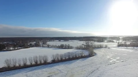 Aerial view  fly over beautiful snowy landscape with sun and blue sky in germany Stock Footage 71484894
