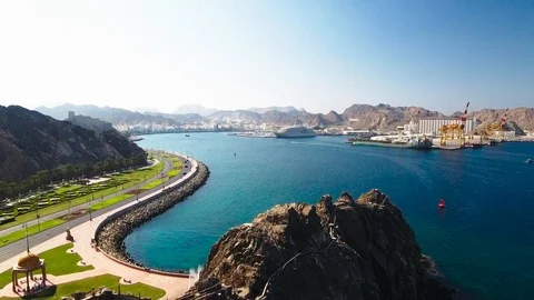 Aerial View of a fly over a mountain revealing port SUltan Qaboos in Muscat, Video stock 86074449