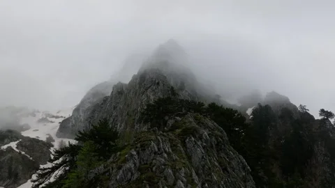 Aerial view fly over the mountain sharp ridge, mountain under the clouds Stock Footage 249999560