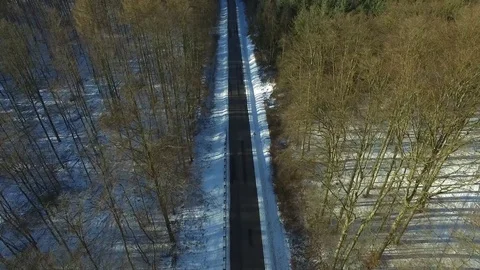 Aerial view fly over road in snowy winter forest landscape - dronen flight Stock Footage 71468178