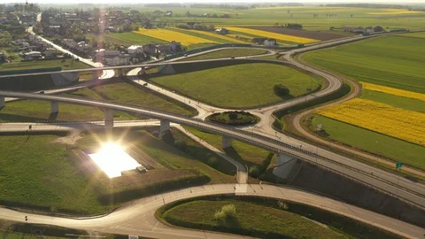 Aerial view - Fly over roads in the fields during sunset in the spring Stock-Footage 129569723