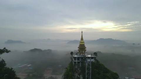 Aerial view of fly through and over high pagoda on top and go over the village Stock Footage 142094082