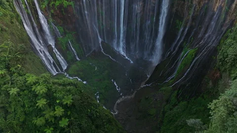 Aerial view fly through trees to Tumpak Sewu waterfall, East Java, Indonesia Stock Footage 252677133