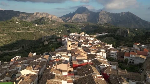 Aerial view flying 90 degrees around old spanish town Tarbena in the mountains Stock Footage 252534670