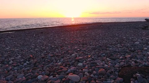 Aerial View. Flying above the sandy beach stone sea at sunset. Stock-Footage 71345904
