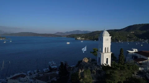 Aerial view. Flying around the clock tower and the Greek flag in Poros. Stock Footage 98157207
