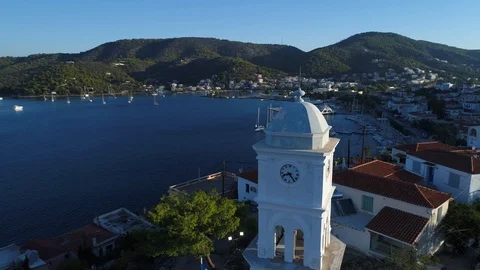 Aerial view. Flying around the clock tower and the Greek flag in Poros. Stock-Footage 98158074