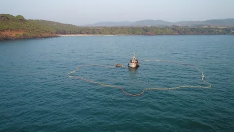 Aerial view. Flying around an old wooden fishing ship in the sea at sunset.  動画素材 101991534