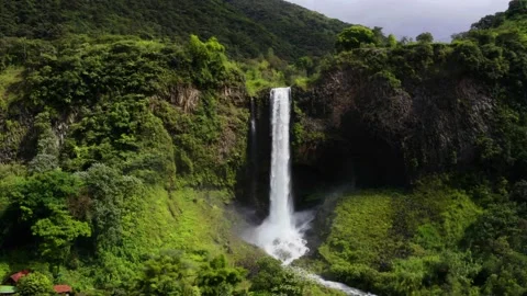Aerial view, flying away from a large, magnificent waterfall Stock Footage 155294057