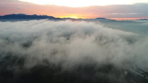 Aerial view. Flying backwards as the clouds passes during beautiful sunrise. Video stock 81224975