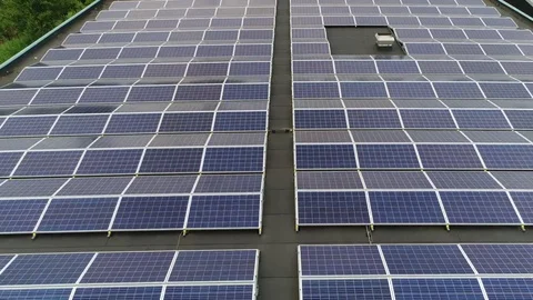 Aerial view flying backwards over modern building roof filled with solar panels Stock Footage 82658763