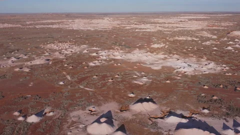 Aerial view flying backwards over opal mine tailings at coober pedy Stock Footage 164844842