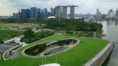 Aerial view flying backwards over the Marina Bay Barrage and skyline of Stock Footage 256986274