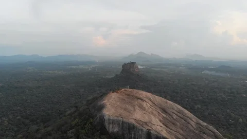 Aerial view flying backwards of Pidurangala and Sigiriya Rock, a must to see in  Stock Footage 90338055