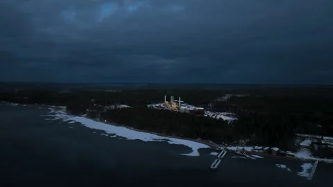 Aerial view flying camera flying toward coal power plant on coast at twilight Stock Footage 295912705