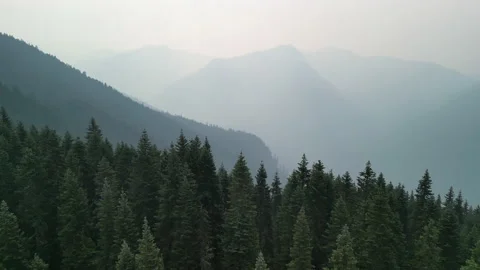 Aerial View Flying Close Over Mountain Ridgeline to Reveal Smoky Canyon Stock Footage 224776578